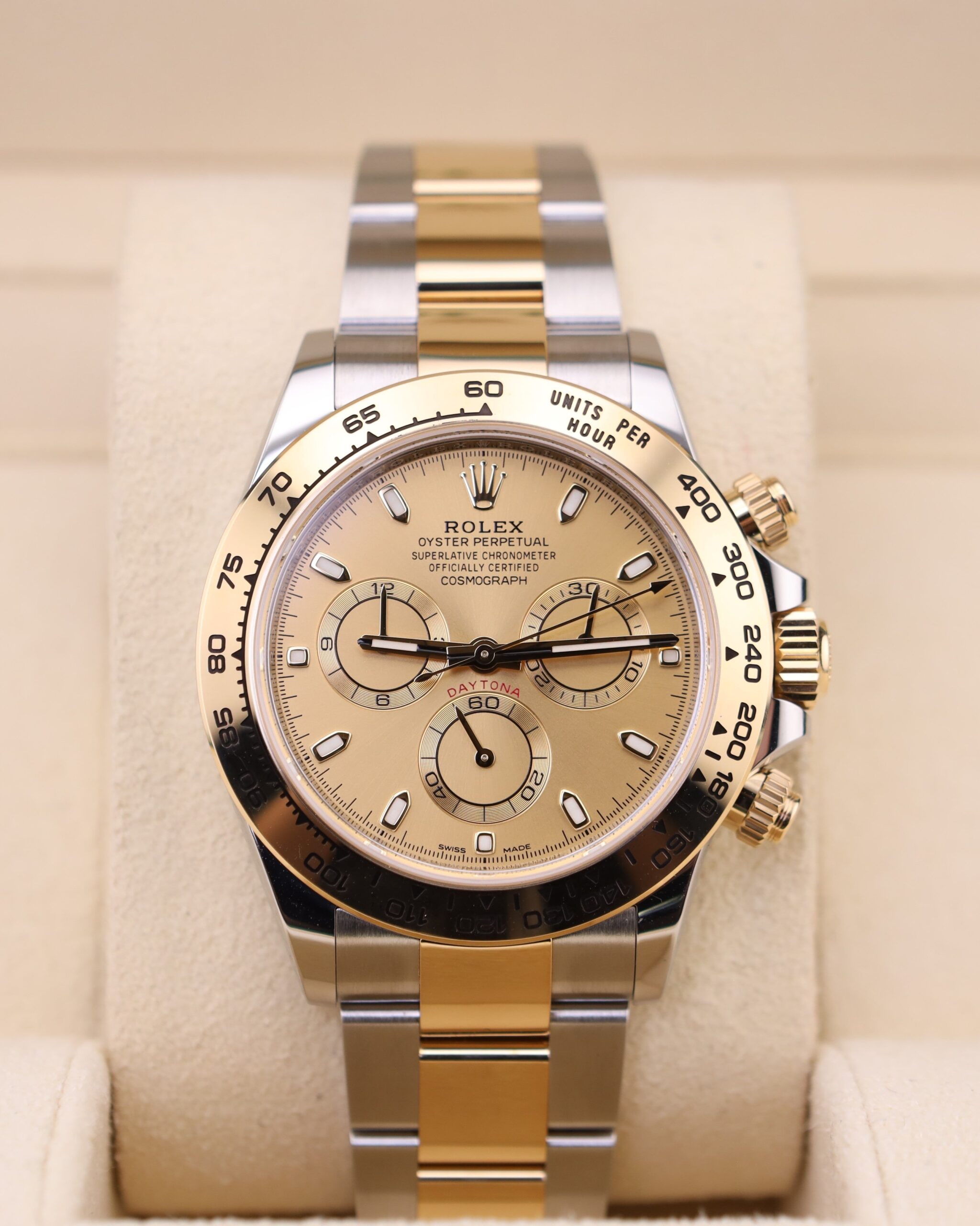 Two-tone chronograph watch on wrist with champagne dial