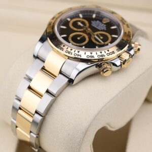 Close-up of black dial two-tone chronograph watch