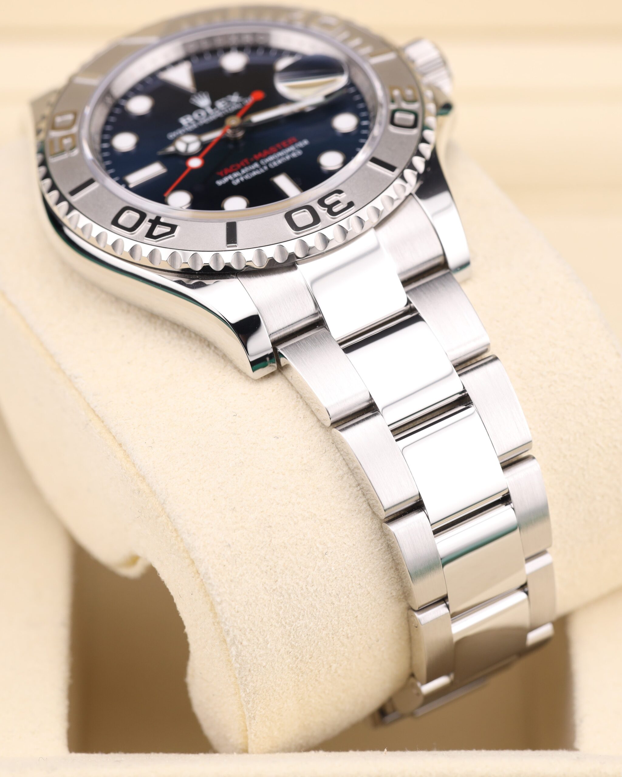 Blue dial watch on wrist with metal strap