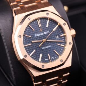 Rose gold watch with blue dial on wrist