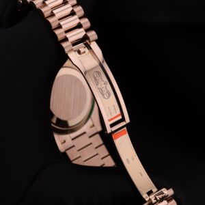 Close-up of pink dial ladies watch with diamond bezel