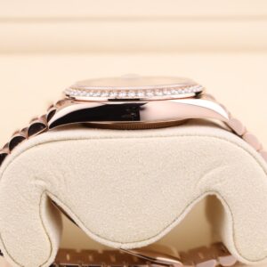 Pink dial watch with diamond markers on stainless steel bracelet
