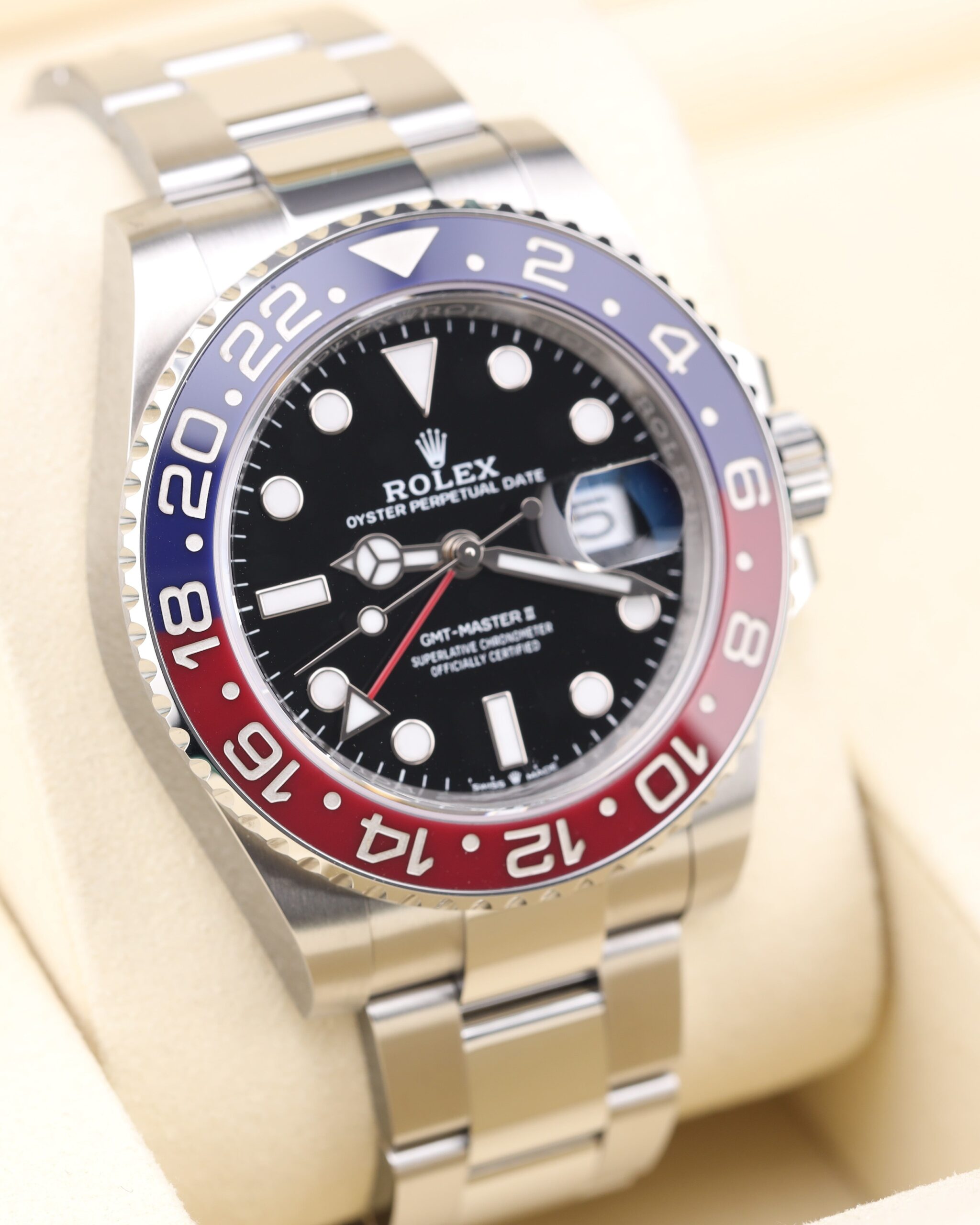 Sporty stainless steel watch with red and blue bezel