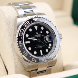 Pre-owned sport luxury timepiece with green bezel