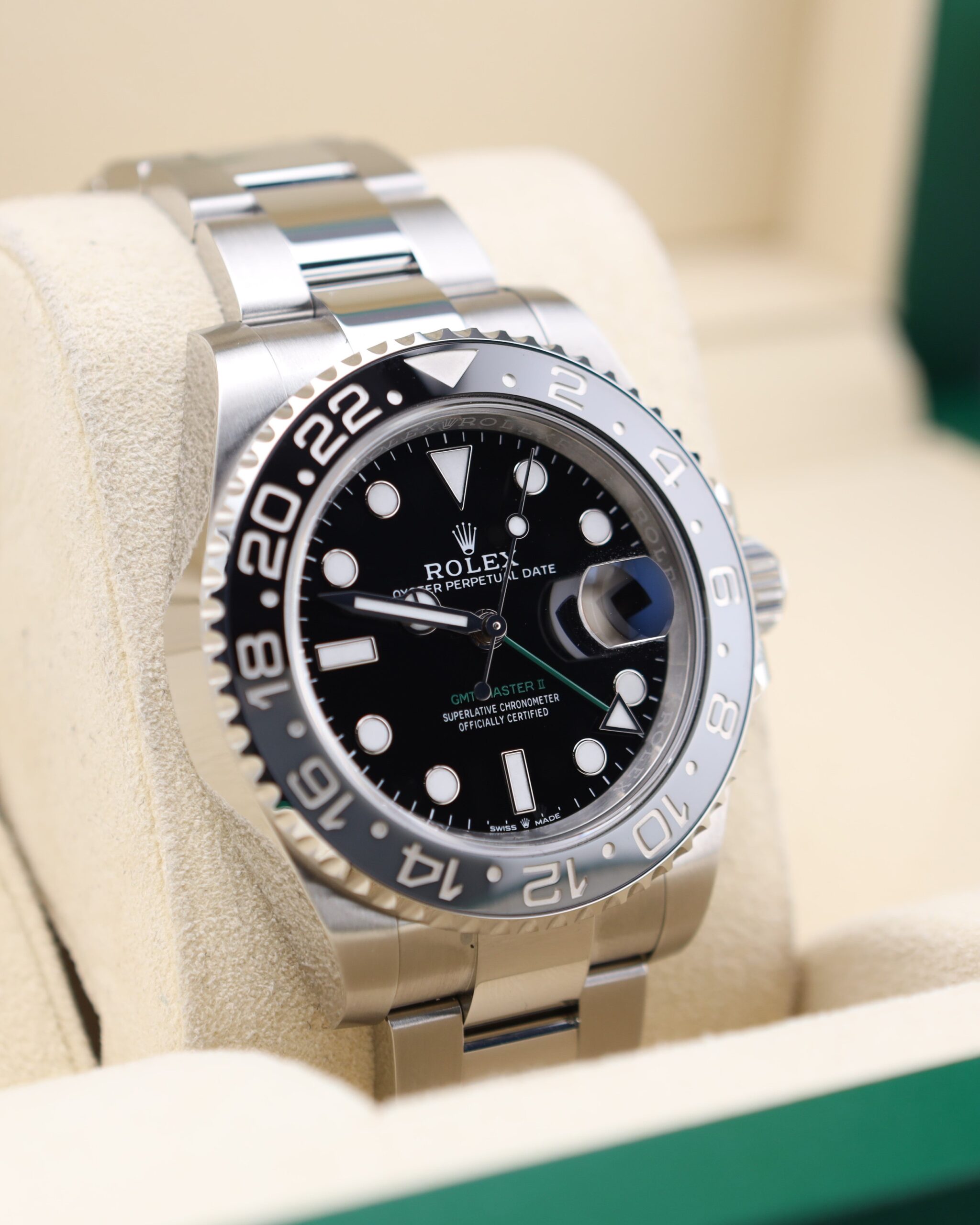 Pre-owned sport luxury timepiece with green bezel