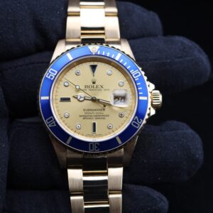 Yellow gold diver watch on wrist with bracelet