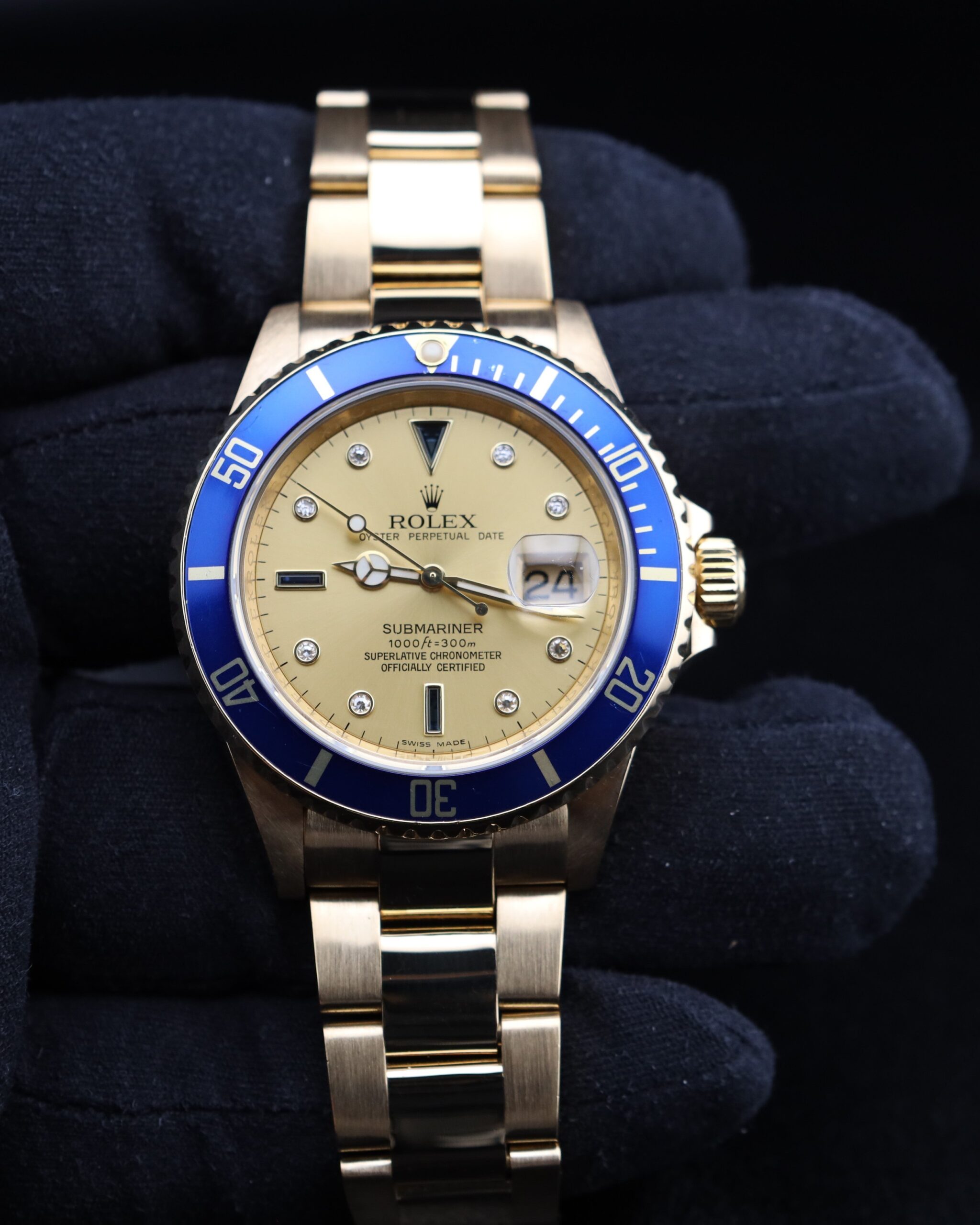 Yellow gold diver watch on wrist with bracelet
