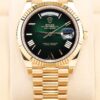 Yellow gold luxury dress watch with green dial
