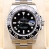 Black dial GMT watch with green arrow hand