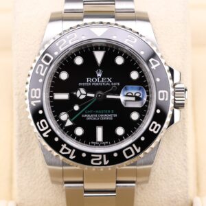 Black dial GMT watch with green arrow hand